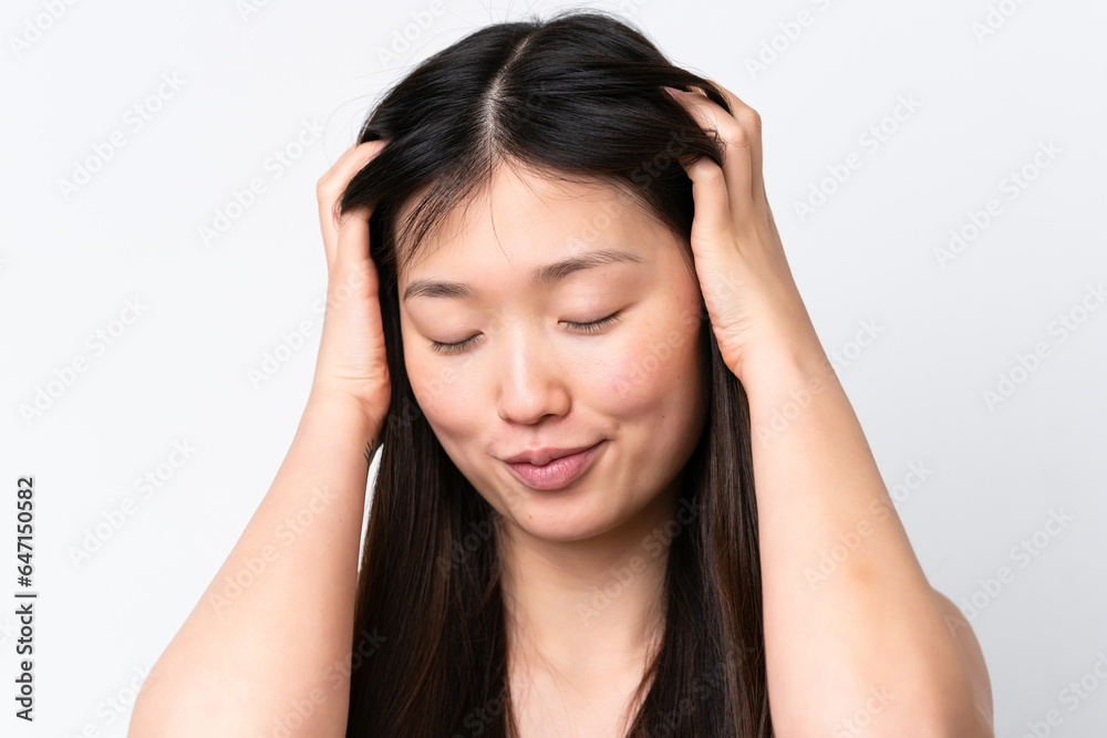Young Chinese woman isolated on white background touching her hair. Close up portrait Young Chinese woman isolated on white background touching her hair. Close up portrait
