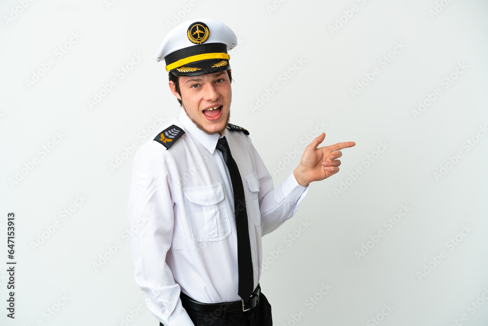Airplane Russian pilot isolated on white background pointing finger to the side and presenting a product