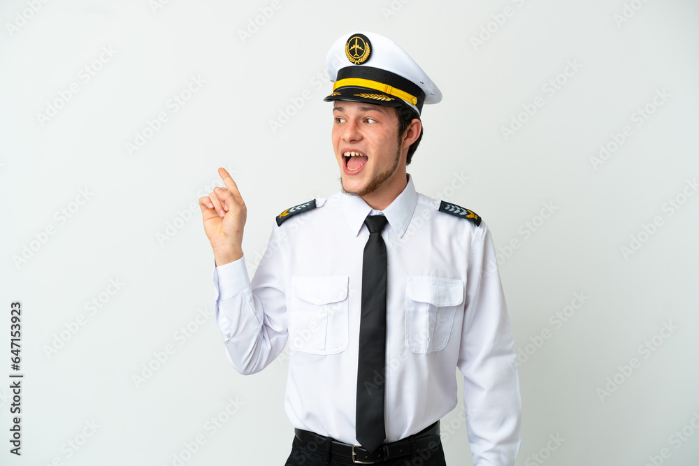 Airplane Russian pilot isolated on white background intending to realizes the solution while lifting a finger up Airplane Russian pilot isolated on white background intending to realizes the solution while lifting a finger up