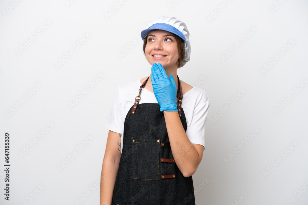 Fishmonger woman wearing an apron looking up while smiling Fishmonger woman wearing an apron looking up while smiling