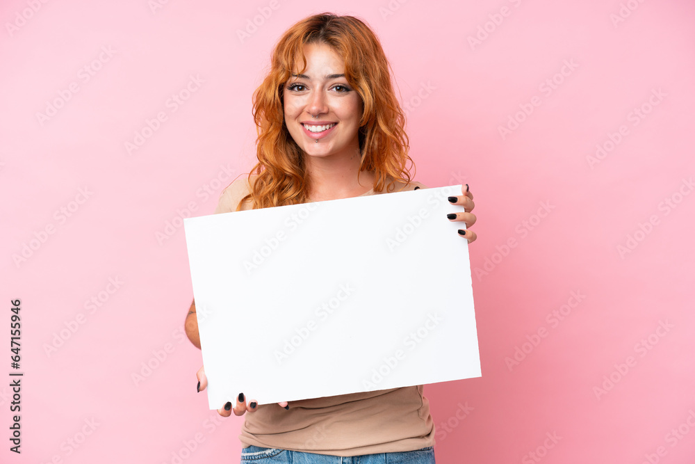 Young caucasian woman isolated on pink background holding an empty placard with happy expression Young caucasian woman isolated on pink background holding an empty placard with happy expression