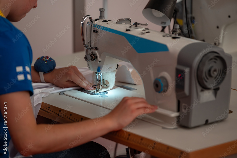 person working on sewing machine