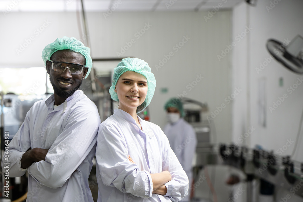 Happy food industry hygiene worker standing smile portrait together mix race man and woman caucasian and black african people professional teamwork.