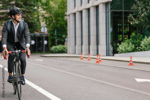 Wallpaper Mural Young man in black suit riding a bike Torontodigital.ca