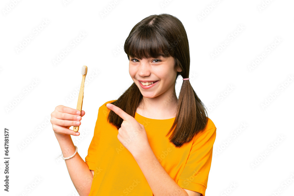 Little caucasian girl brushing teeth over isolated background and pointing it Little caucasian girl brushing teeth over isolated background and pointing it