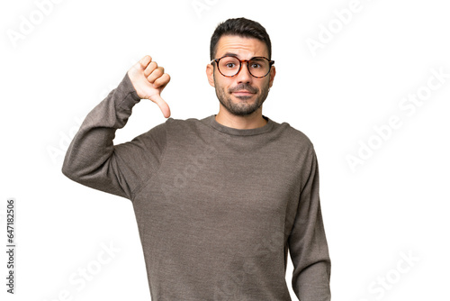 Photography Young handsome caucasian man over isolated background showing thumb down with ne