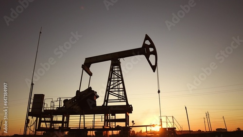 oil production. silhouette oil and gas production rig at sunset glare. oilfield business a extraction concept. oil extraction pump. Oil pump lifestyle rig