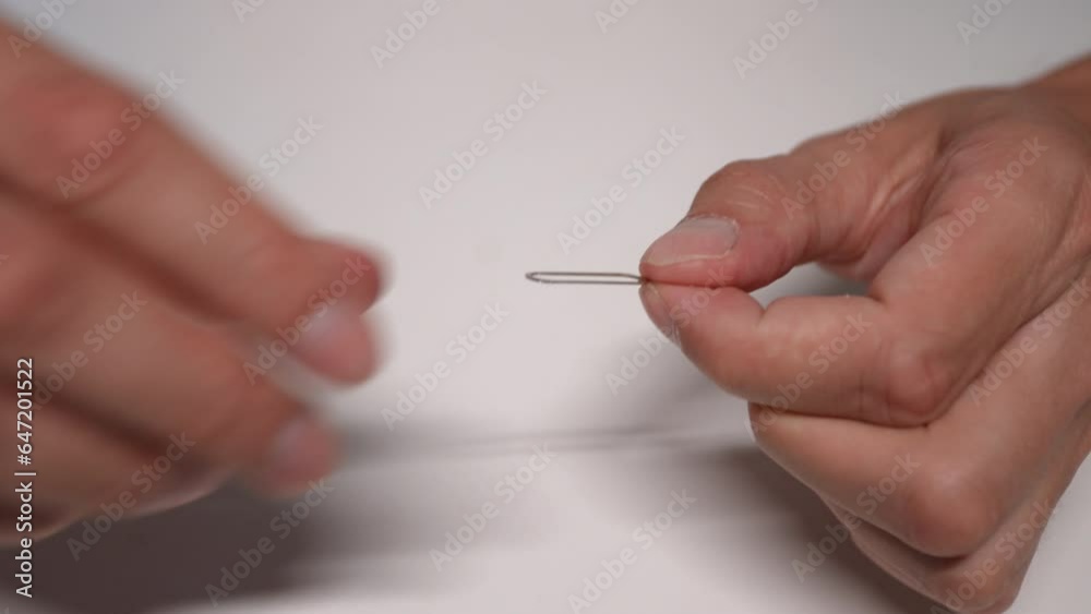Close-up unrecognizable male hands pulls ejector out of packaging while unpacking box with new smartphone. Closeup of man prepare to install SIM card in purchased mobile phone. Shooting in slow motion Close-up unrecognizable male hands pulls ejector out of packaging while unpacking box with new smartphone. Closeup of man prepare to install SIM card in purchased mobile phone. Shooting in slow motion
