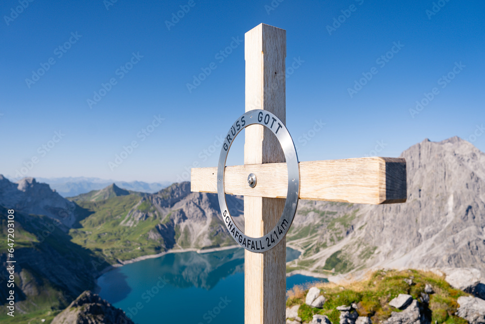 A cross atop a hill in Austria signifies the summit, a symbol of the highest point. The mountain SCHAFGAFALL (2,414 m) stands as a testament to nature's grandeur and the allure of reaching new heights - obrazy, fototapety, plakaty 