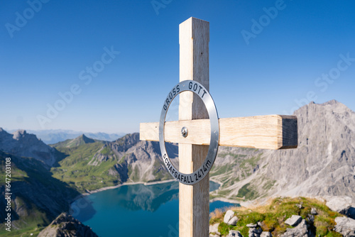 A cross atop a hill in Austria signifies the summit, a symbol of the highest point. The mountain SCHAFGAFALL (2,414 m) stands as a testament to nature's grandeur and the allure of reaching new heights