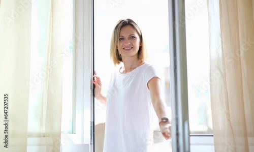 Young woman opening door and entering apartment. Ventilation of houses fresh air in apartments concept Free Download Young woman opening door and entering apartment. Ventilation of houses fresh air in apartments concept - GFXLoad
