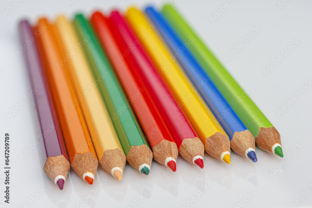 colorful wooden crayons on a light background colorful wooden crayons on a light background