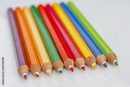 colorful wooden crayons on a light background