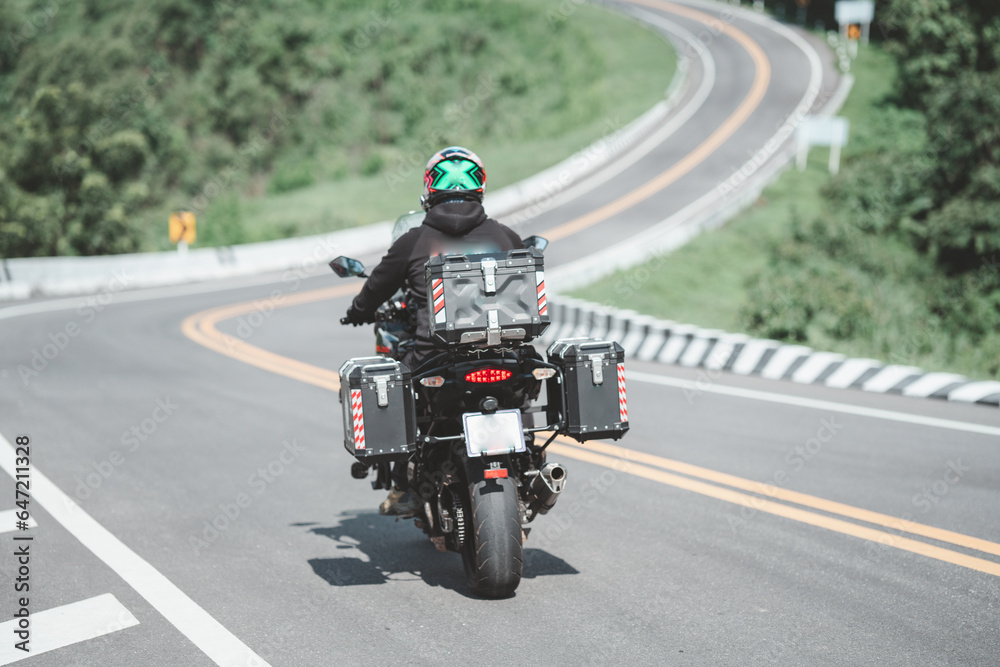 motorcycle on the road rides away. Travel on vacation, enjoy the nature trail. motorcycle in a sunny motorbike on the road riding.with sunset light. copyspace for your individual text. motorcycle on the road rides away. Travel on vacation, enjoy the nature trail. motorcycle in a sunny motorbike on the road riding.with sunset light. copyspace for your individual text.