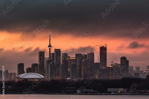 A vibrant Toronto skyline with tall buildings under a dusky sky symbolizing economy and commerce. Generative AI
