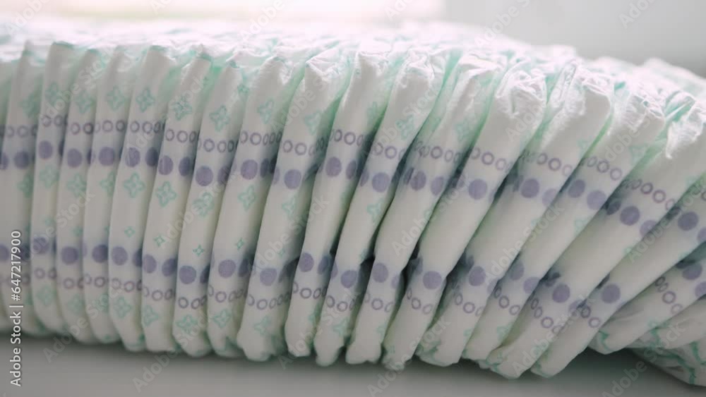 a large stack of many diapers for children. Modern cotton diapers, protection against leakage and diaper rash in children, close-up a large stack of many diapers for children. Modern cotton diapers, protection against leakage and diaper rash in children, close-up