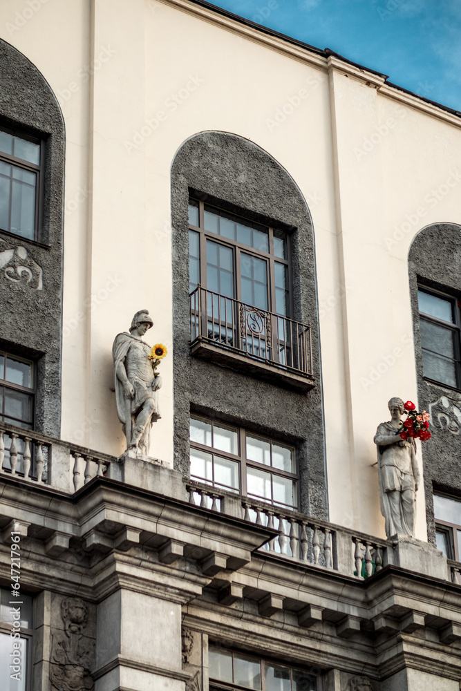Beautiful antique statues on ancient buildings in the city.