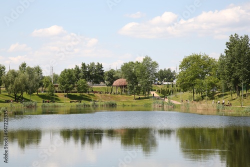 Beautiful park with green trees and lake
