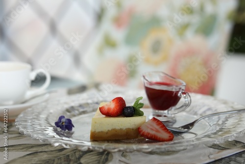 Slice of delicious cheesecake with fresh berries served on table in restaurant, closeup. Space for text