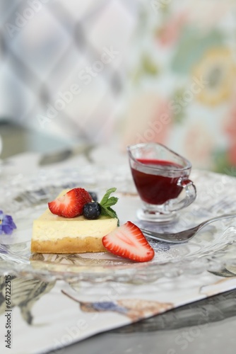 Slice of delicious cheesecake with fresh berries served on table in restaurant, closeup. Space for text