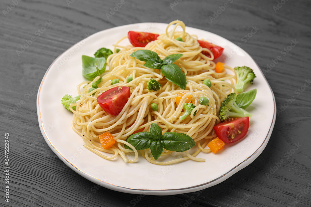 Delicious pasta primavera with tomatoes, basil and broccoli on grey table, closeup