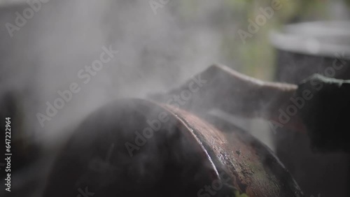 Detail of illegal domestic production with homemade distillery made of copper making moonshine schnapps, alcoholic beverages such as brandy vodka cognac whiskey bourbon gin tequila, slow motion photo