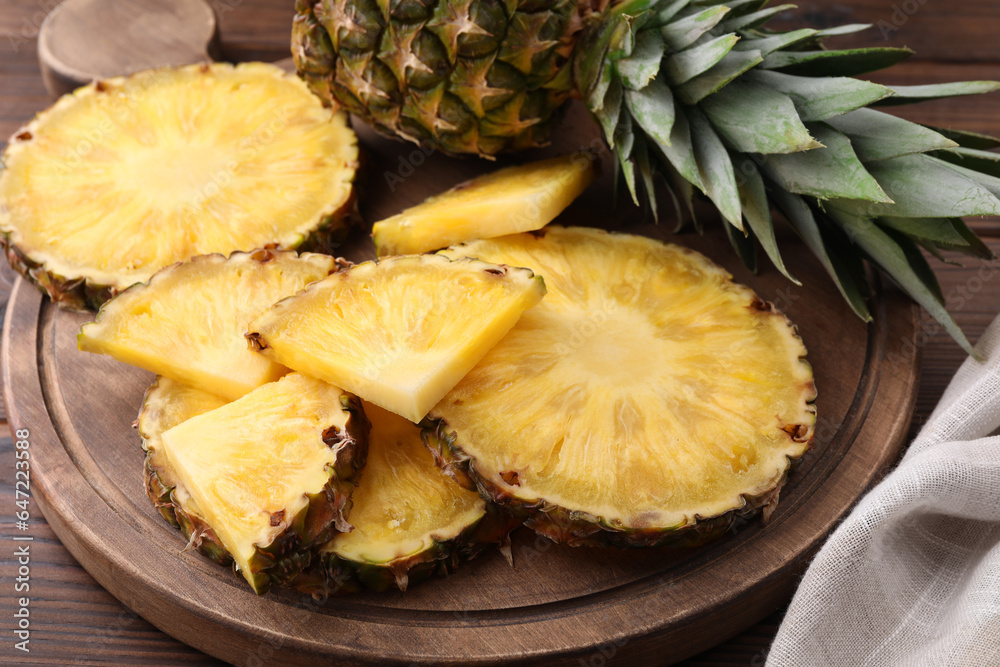 Pieces of tasty ripe pineapple on table, closeup Pieces of tasty ripe pineapple on table, closeup
