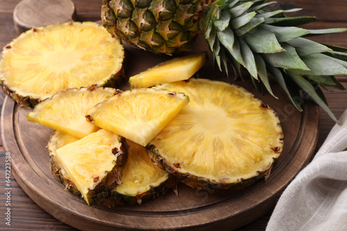Pieces of tasty ripe pineapple on table, closeup
