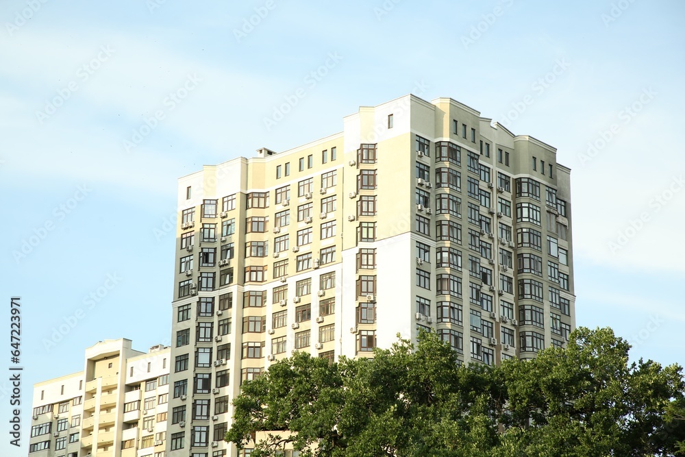 Exterior of beautiful building with many windows against blue sky