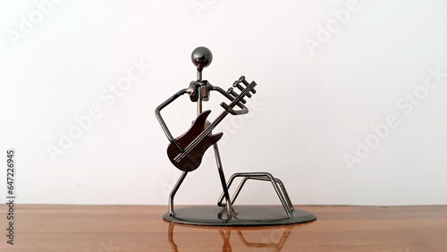 Showpiece of metal presentiing a man holding guitar. black steel symbolic piece of music colver. Cover pic for any musical event or concert. Background for music, guitar, guitarist or any art form photo
