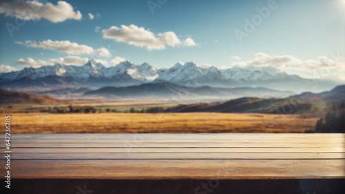An empty wooden table on a blurred mountain landscape background can be used to display or assemble your products. High quality photography, space for text. © anandart