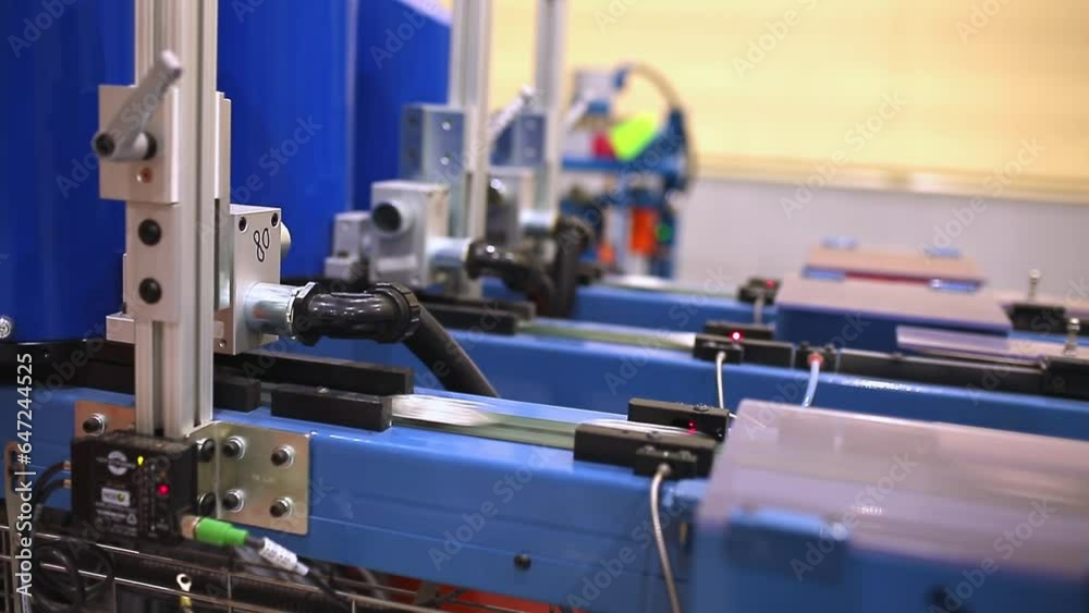 Modern factory for the production of food packaging. Production of aluminum cans. A mechanical press extrudes aluminum can blanks from food-grade aluminum foil. Modern factory for the production of food packaging. Production of aluminum cans. A mechanical press extrudes aluminum can blanks from food-grade aluminum foil.
