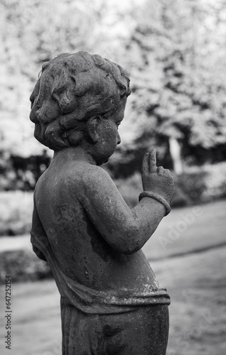 a sculpture in a park of a boy