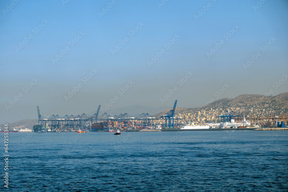 Piraeus port, Attica Greece. Industrial zone, container terminal, moored cargo ship. Sea, blue sky.