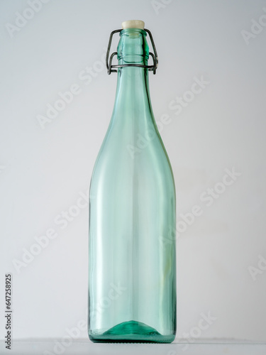 Transparent glass bottle on white background