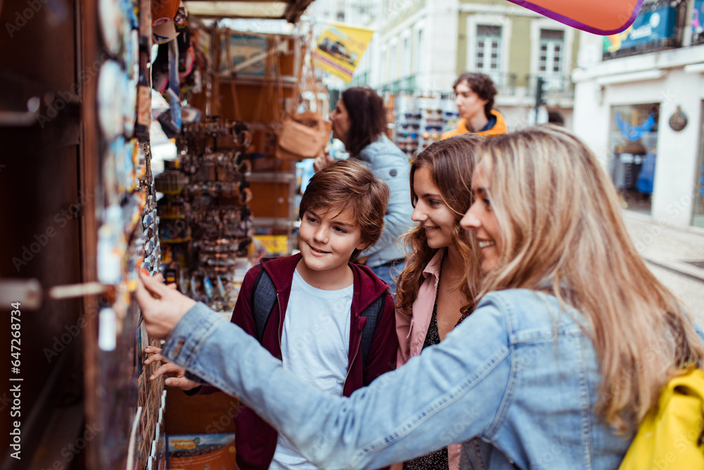 Young Caucasian family traveling and browsing a souvenir shop in the city