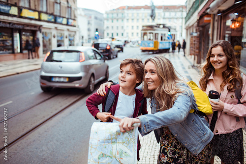 Young mother traveling and exploring the city of Lisbon in Portugal with her children
