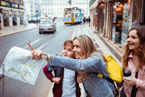 Young mother traveling and exploring the city of Lisbon in Portugal with her children