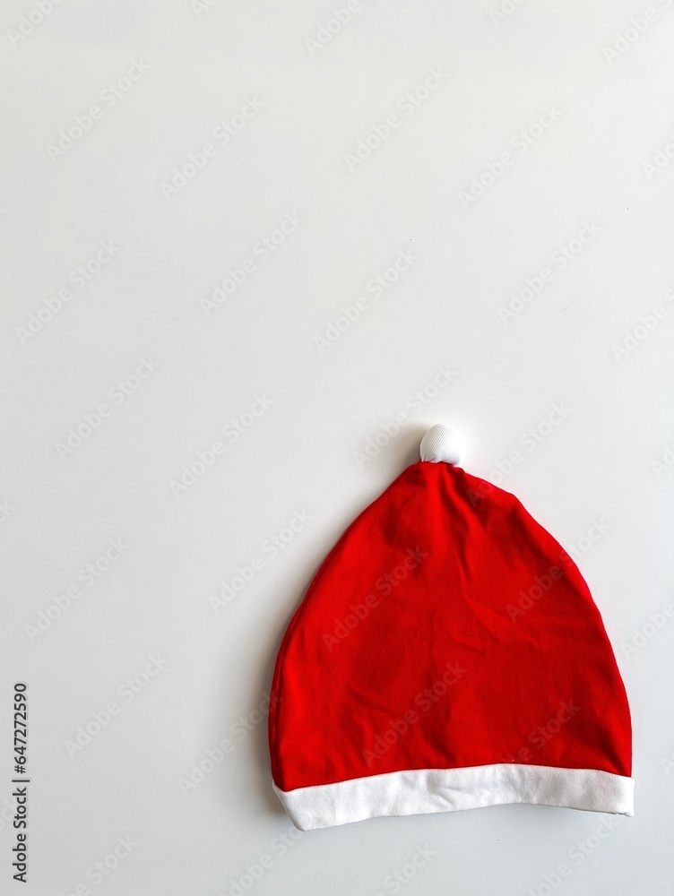 Christmas minimal composition. Children's Santa Claus hat on a white background. Christmas, New Year, winter concept. Flat lay, top view, copy space, santa claus hat