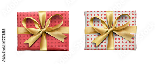 Obraz na płótnie A top view of two Christmas or birthday presents from above with gold ribbon bows with red spotted pattern on the wrapping paper isolated against a transparent background. w salonie