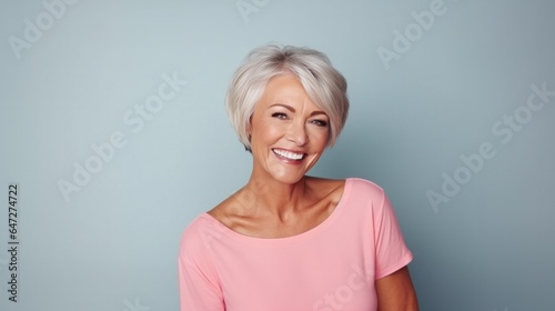 Senior female studio portrait. Short grey hair senior model. Fashion photography in studio.