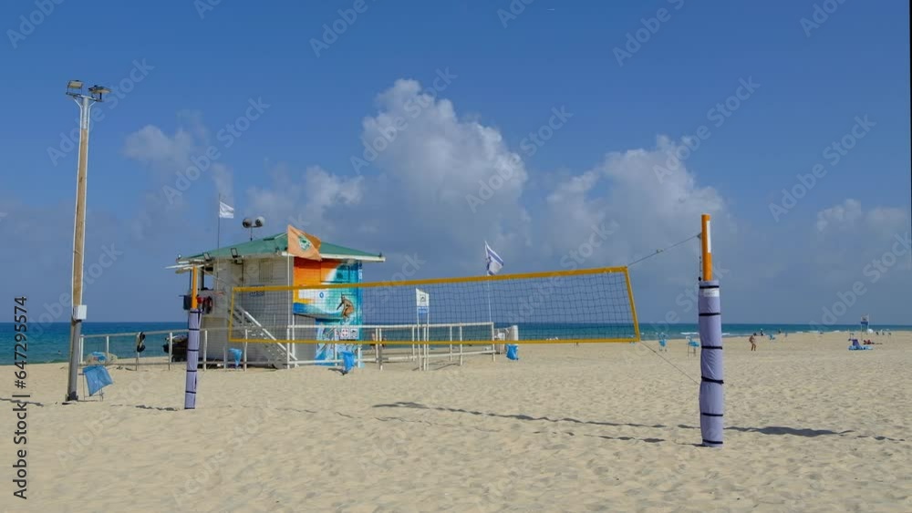 Volleyball net at the beach, lifeguard tower at the beach Volleyball net at the beach, lifeguard tower at the beach