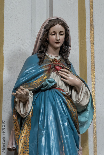 A colorful statue of the Virgin Mary in the interior.