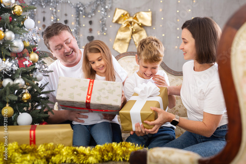 Portrait of family who is satisfied of gifts in time celebration New Year at home