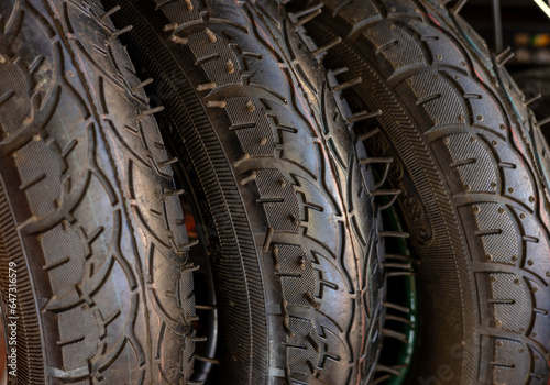 bike front wheel motorcycle tires in row for sale, shop store.orange black mountain tyre.