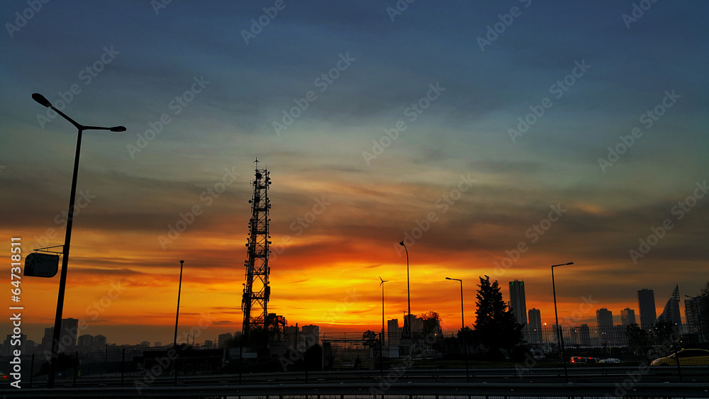 Mobile cellular wireless communication antenna tower against sunset sky in Istanbul Turkey.