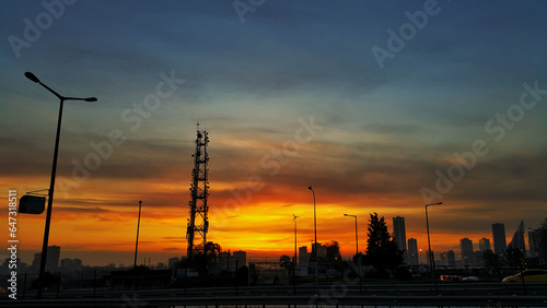 Mobile cellular wireless communication antenna tower against sunset sky in Istanbul Turkey.