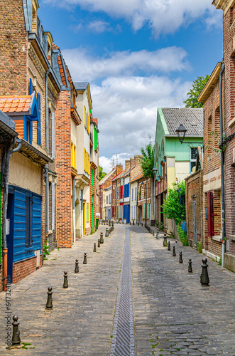 Amiens historical city centre Saint-Leu quarter with narrow street between colorful houses buildings with brick walls. France landmarks, Somme department, Hauts-de-France Region, Northern France