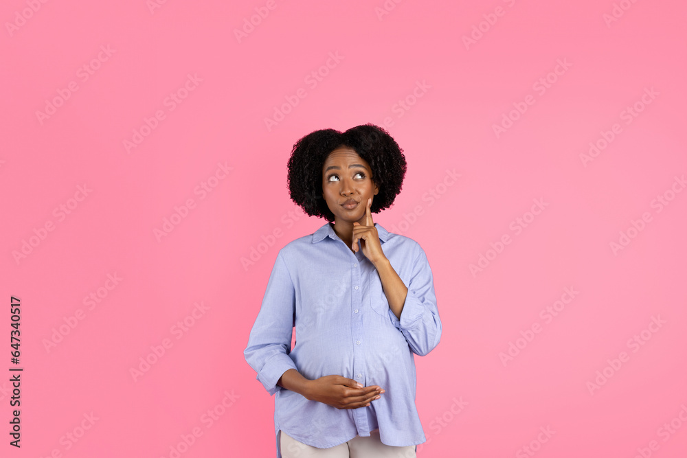 Pensive millennial black pregnant lady touching big belly, thinking looking at copy space, enjoy motherhood Pensive millennial black pregnant lady touching big belly, thinking looking at copy space, enjoy motherhood