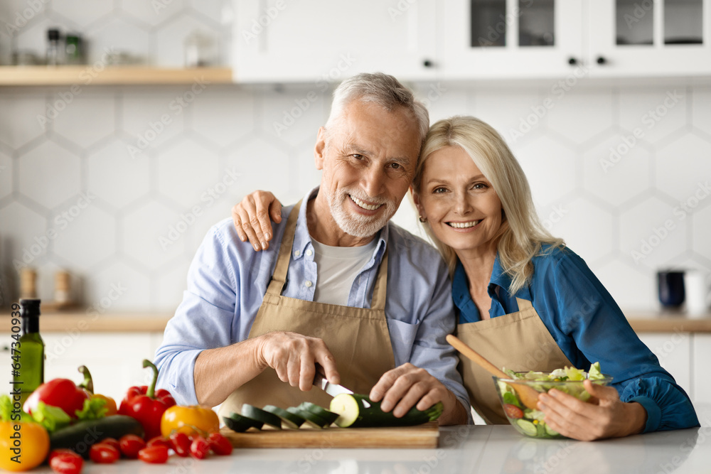 Photo of cheerful senior man and woman cooking together at home Photo of cheerful senior man and woman cooking together at home